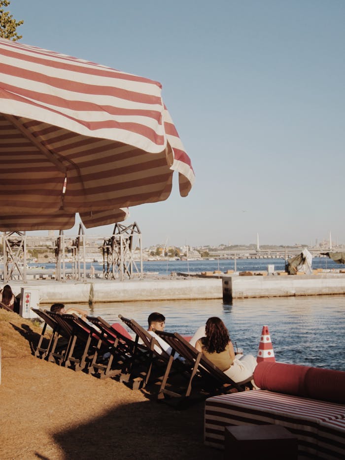 services-04 relaxing-riverside-scene-with-deck-chairs-and-umbrellas-33270681